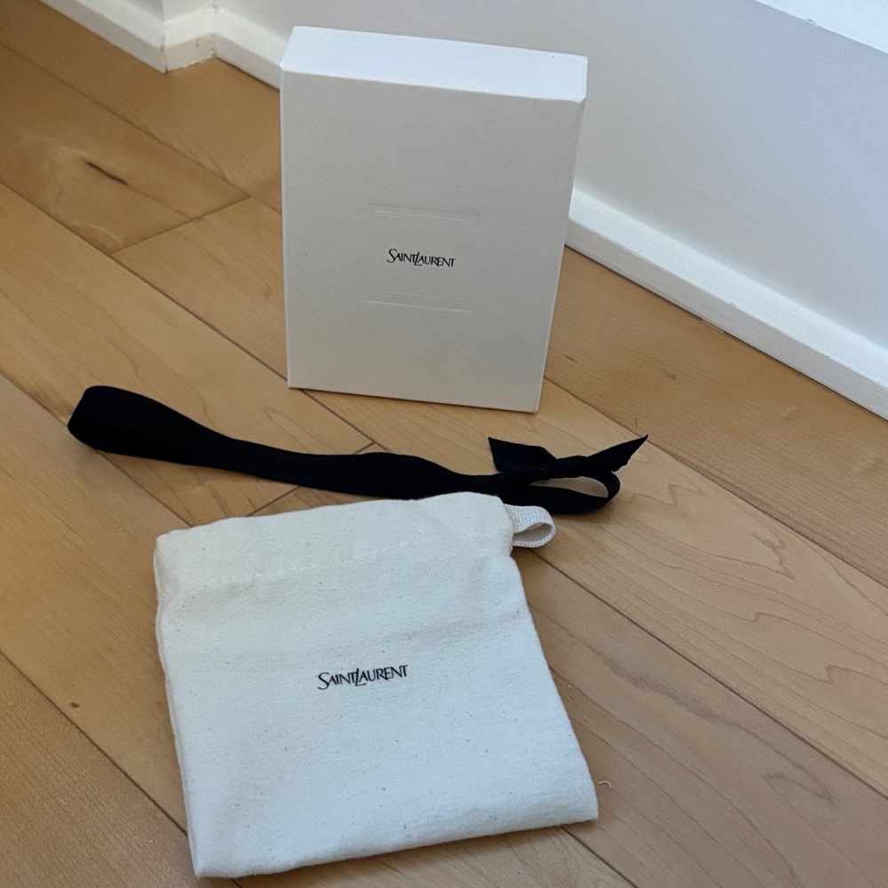 Saint Laurent Cream Pouch with Black Strap
For small wallets